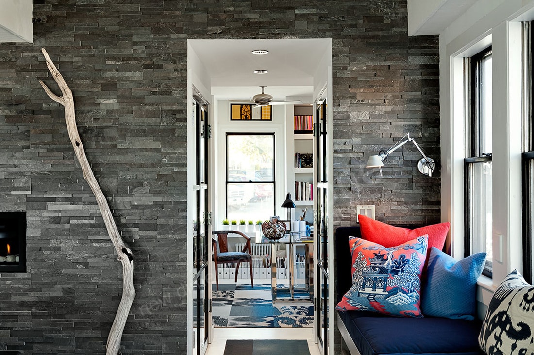 Window seat nook at the end of a long kitchen with a stone veneer accent wall in Austin, TX